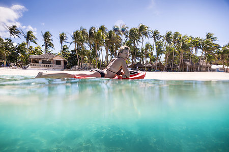 Surfer gliding in sea, Pagudpud, Ilocos Norte, Philippines Stock Photo - Premium Royalty-Free, Code: 649-09251397
