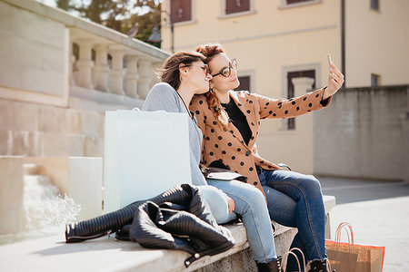 Female shoppers taking selfie in front of fountain, Arezzo, Toscana, Italy Stock Photo - Premium Royalty-Free, Code: 649-09251504