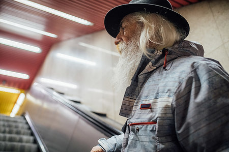 Senior man going up escalator Fotografie stock - Premium Royalty-Free, Codice: 649-09251528