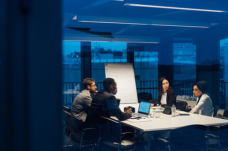 Businessmen and women having discussion during conference table meeting Stock Photo - Premium Royalty-Free, Code: 649-09251612