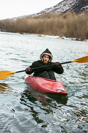 Young man kayaking on river in winter, portrait, Domodossola, Piemonte, Italy Stock Photo - Premium Royalty-Free, Code: 649-09251787