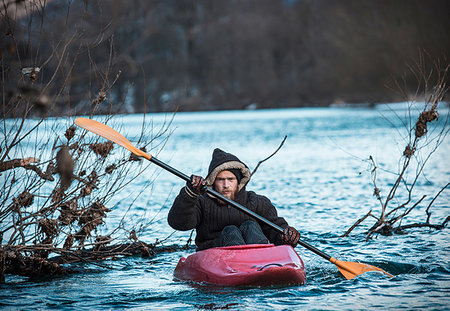 Young man kayaking on river in winter, portrait, Domodossola, Piemonte, Italy Stock Photo - Premium Royalty-Free, Code: 649-09251790