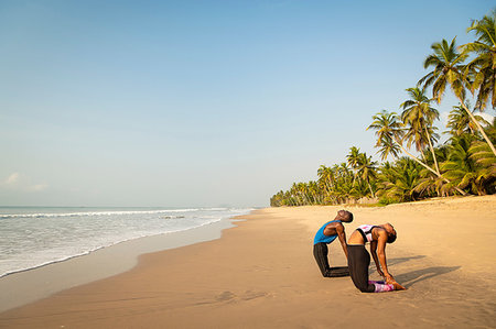 simsearch:649-09251967,k - Couple practising yoga on beach Stock Photo - Premium Royalty-Free, Code: 649-09251965