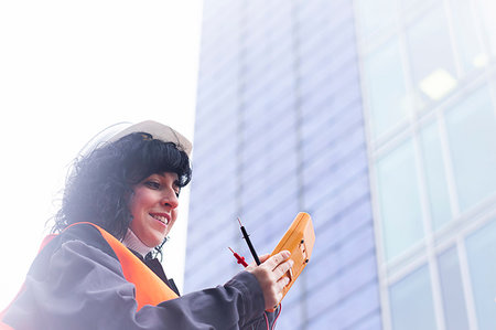 simsearch:649-08577535,k - Female surveyor looking at distance meter outside office building Stock Photo - Premium Royalty-Free, Code: 649-09268629