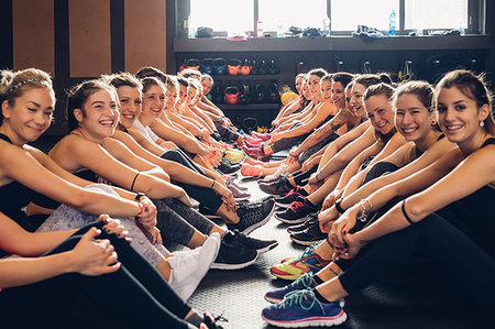 simsearch:649-07585305,k - Large group of women training in gym, sitting on floor, portrait Stock Photo - Premium Royalty-Free, Code: 649-09268848