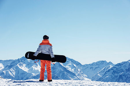 simsearch:649-08900389,k - Teenage boy snowboarder looking out over landscape from snow covered mountain top, rear view, Alpe-d'Huez, Rhone-Alpes, France Stock Photo - Premium Royalty-Free, Code: 649-09268964