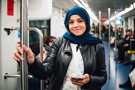 simsearch:649-09061458,k - Young woman in hijab with smartphone on subway train, portrait Stock Photo - Premium Royalty-Free, Code: 649-09269058