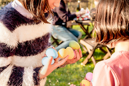 simsearch:649-07239783,k - Two girl with handfuls of dyed Easter eggs at table, cropped Stock Photo - Premium Royalty-Free, Code: 649-09269141