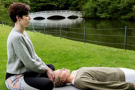 simsearch:614-08487979,k - Woman practising Reiki on grass lawn by river, London, UK Stock Photo - Premium Royalty-Free, Code: 649-09269296