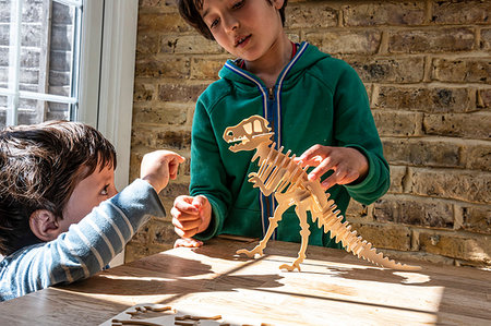 simsearch:649-09269303,k - Boy showing brother way to build wooden dinosaur Stock Photo - Premium Royalty-Free, Code: 649-09269299
