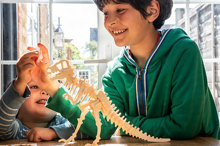simsearch:649-09269303,k - Boy and little brother playing with wooden dinosaur Stock Photo - Premium Royalty-Free, Code: 649-09269305