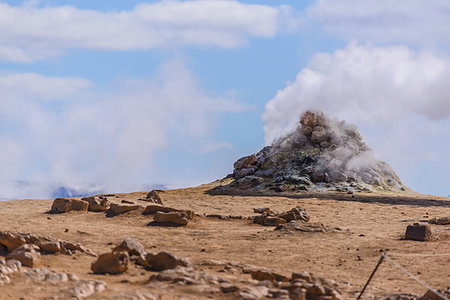 fumarole - Hillside landscape with rock formation and rising steam against blue sky, Akureyri, Eyjafjardarsysla, Iceland Stock Photo - Premium Royalty-Free, Code: 649-09275666