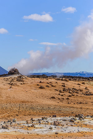 fumarole - Hillside landscape with rock formation and rising steam against blue sky, Akureyri, Eyjafjardarsysla, Iceland Stock Photo - Premium Royalty-Free, Code: 649-09275662