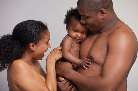 simsearch:614-09249646,k - Mother tickling baby boy in father's arms Fotografie stock - Premium Royalty-Free, Codice: 649-09275939