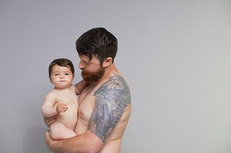 dad with tattoos - Portrait of father with baby girl Stock Photo - Premium Royalty-Free, Code: 649-09275959