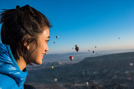 simsearch:649-09111386,k - Woman enjoying view, hot air balloons flying in background, Göreme, Cappadocia, Nevsehir, Turkey Stock Photo - Premium Royalty-Free, Code: 649-09276048