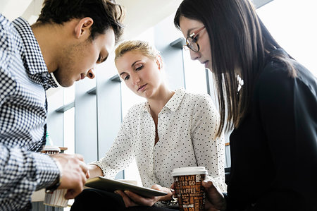 simsearch:649-08901059,k - Businessman and businesswomen using digital tablet at meeting in office Photographie de stock - Premium Libres de Droits, Code: 649-09277633