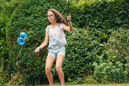 simsearch:649-06533075,k - Girl playing with diabolo in garden Stock Photo - Premium Royalty-Free, Code: 649-09277873