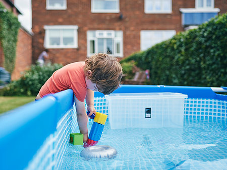 simsearch:632-06317745,k - Boy filling up water gun from pool water Photographie de stock - Premium Libres de Droits, Code: 649-09277893