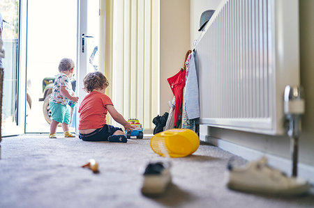 photo sitting on radiator - Boys playing with toy trucks and assorted toys on rug Stock Photo - Premium Royalty-Free, Code: 649-09277914