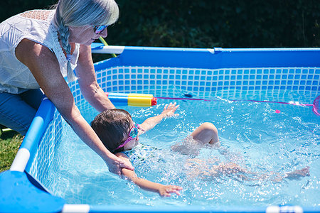 simsearch:649-06113662,k - Grandmother supporting granddaughter in pool Photographie de stock - Premium Libres de Droits, Code: 649-09277924