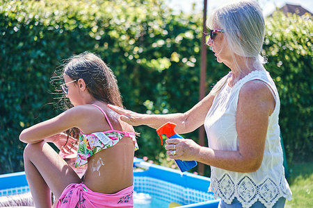 Grandmother putting sun lotion on granddaughter Stock Photo - Premium Royalty-Free, Code: 649-09277920