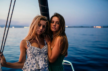 friends sailing - Portrait of friends on sailboat in evening, Italy Stock Photo - Premium Royalty-Free, Code: 649-09277994