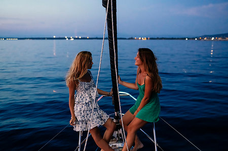 friends sailing - Friends relaxing on sailboat in evening, Italy Stock Photo - Premium Royalty-Free, Code: 649-09277995