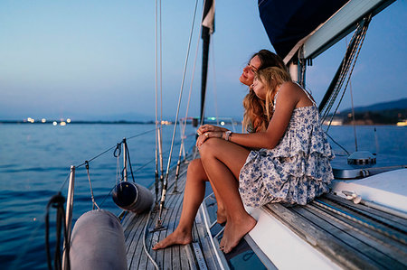 friends sailing - Close friends relaxing on sailboat in evening, Italy Stock Photo - Premium Royalty-Free, Code: 649-09277996