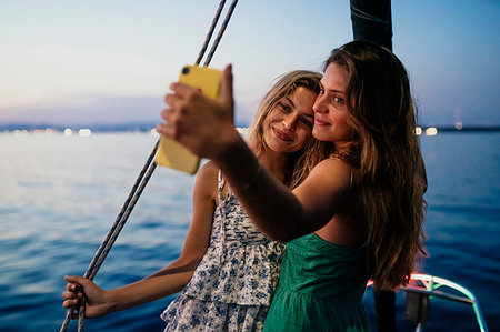 friends sailing - Friends taking selfie on sailboat, Italy Stock Photo - Premium Royalty-Free, Code: 649-09277993