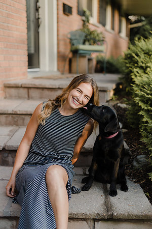 Pet dog licking woman on garden steps Stock Photo - Premium Royalty-Free, Code: 649-09278114