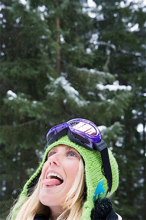 sticking out tongue in snow - Close-up of young blonde woman wearing ski-wear sticking tongue out to catch snow Stock Photo - Premium Royalty-Free, Code: 649-01556073