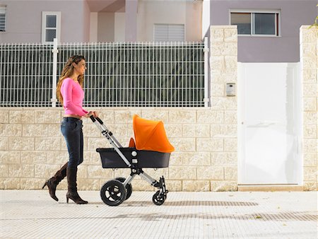 pushing door - Mother pushing pram on pavement, Alicante, Spain, Stock Photo - Premium Royalty-Free, Code: 649-01556894