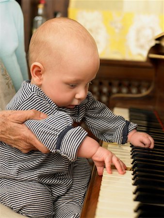Senior grandmother holding baby grandson (1-3 months) pressing piano keys Stock Photo - Premium Royalty-Free, Code: 649-01556983