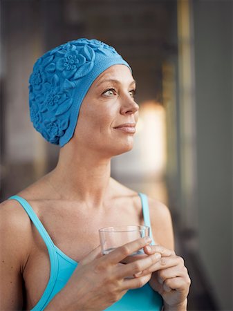 swimming suit with cap - Mature woman wearing bathing suit, holding glass of water Stock Photo - Premium Royalty-Free, Code: 649-01557785