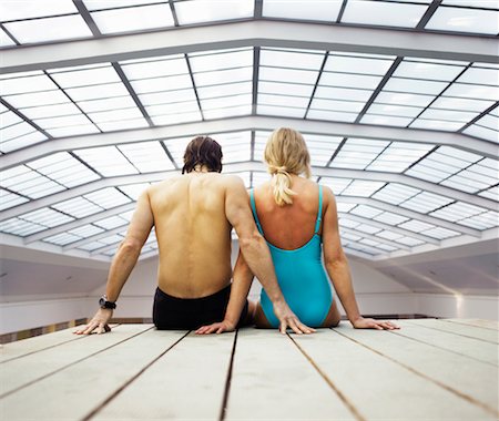 Mature couple sitting on decking indoors, rear view Stock Photo - Premium Royalty-Free, Code: 649-01557798