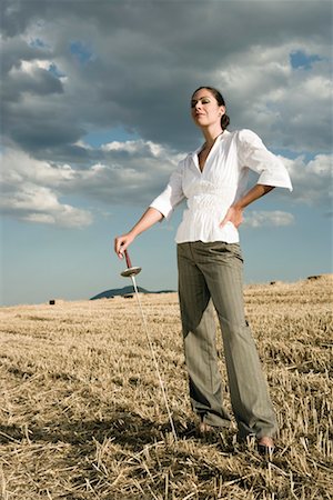 Woman standing with sword in wheat field. Stock Photo - Premium Royalty-Free, Code: 649-01608605