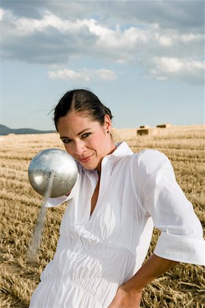 Woman pointing sword in wheat field. Stock Photo - Premium Royalty-Free, Code: 649-01608607
