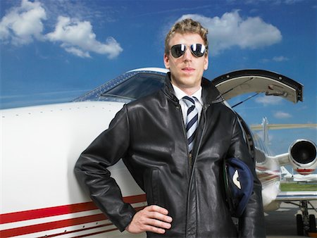 plane runway people - Pilot standing beside private jet. Stock Photo - Premium Royalty-Free, Code: 649-01608659