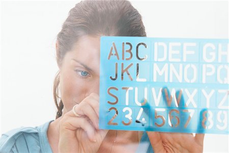 Close-Up portrait of woman through window using graphic drawing equipment. Stock Photo - Premium Royalty-Free, Code: 649-01609134