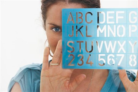 Close-Up portrait of woman through window using graphic drawing equipment. Stock Photo - Premium Royalty-Free, Code: 649-01609132