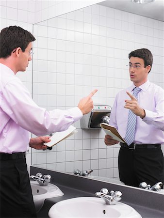 prova (spettacolo) - Man practicing speech in office washroom mirror Fotografie stock - Premium Royalty-Free, Codice: 649-01610220