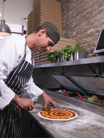 pizza restaurant - Pizza chef making pizza Stock Photo - Premium Royalty-Free, Code: 649-01610403