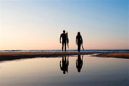Couple standing on the beach with surfboards. Stock Photo - Premium Royalty-Free, Code: 649-01696110