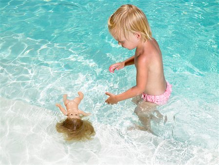 simsearch:649-02731940,k - Young boy playing with a doll in a pool. Stock Photo - Premium Royalty-Free, Code: 649-01696508