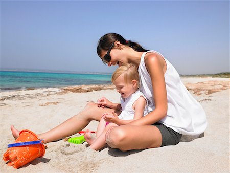 Woman and young boy at the beach playing and smiling. Stock Photo - Premium Royalty-Free, Code: 649-01696520