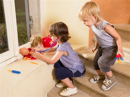 social gathering france - Little girls playing doctor with doll. Stock Photo - Premium Royalty-Free, Code: 649-01754278