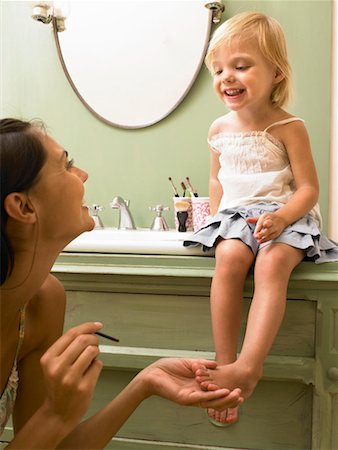 social gathering france - Mother and daughter applying makeup. Stock Photo - Premium Royalty-Free, Code: 649-01754341