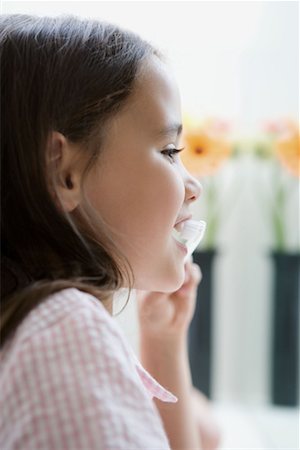 Portrait of a girl brushing teeth. Stock Photo - Premium Royalty-Free, Code: 649-01755010