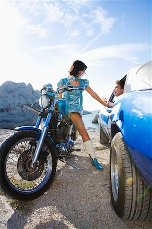Man in car woman on motorbike. Stock Photo - Premium Royalty-Free, Code: 649-01753895